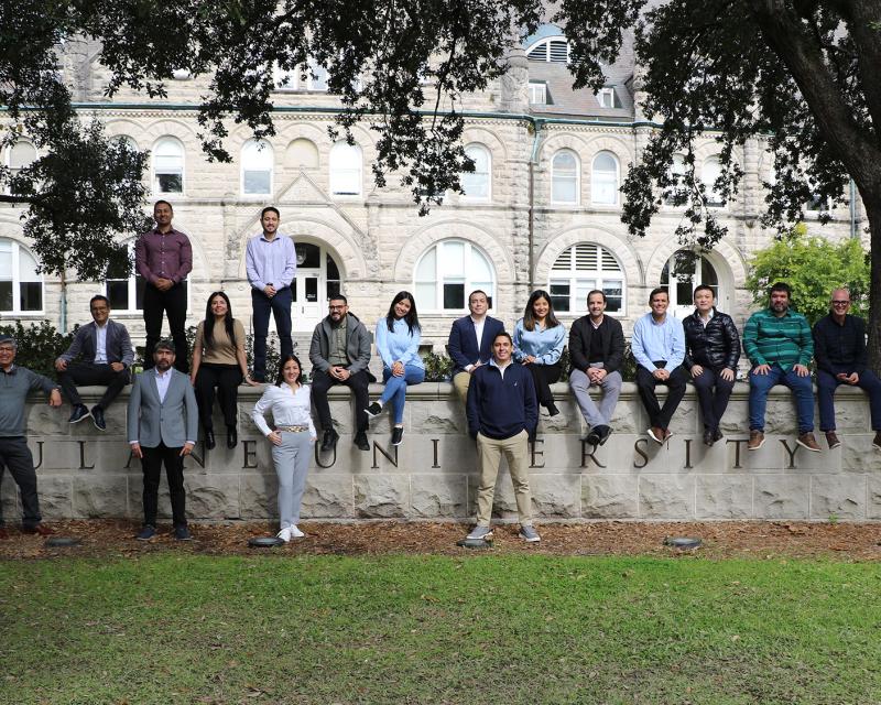 Goldring Institute for International Business students seated on a Tulane campus structure in 2025.